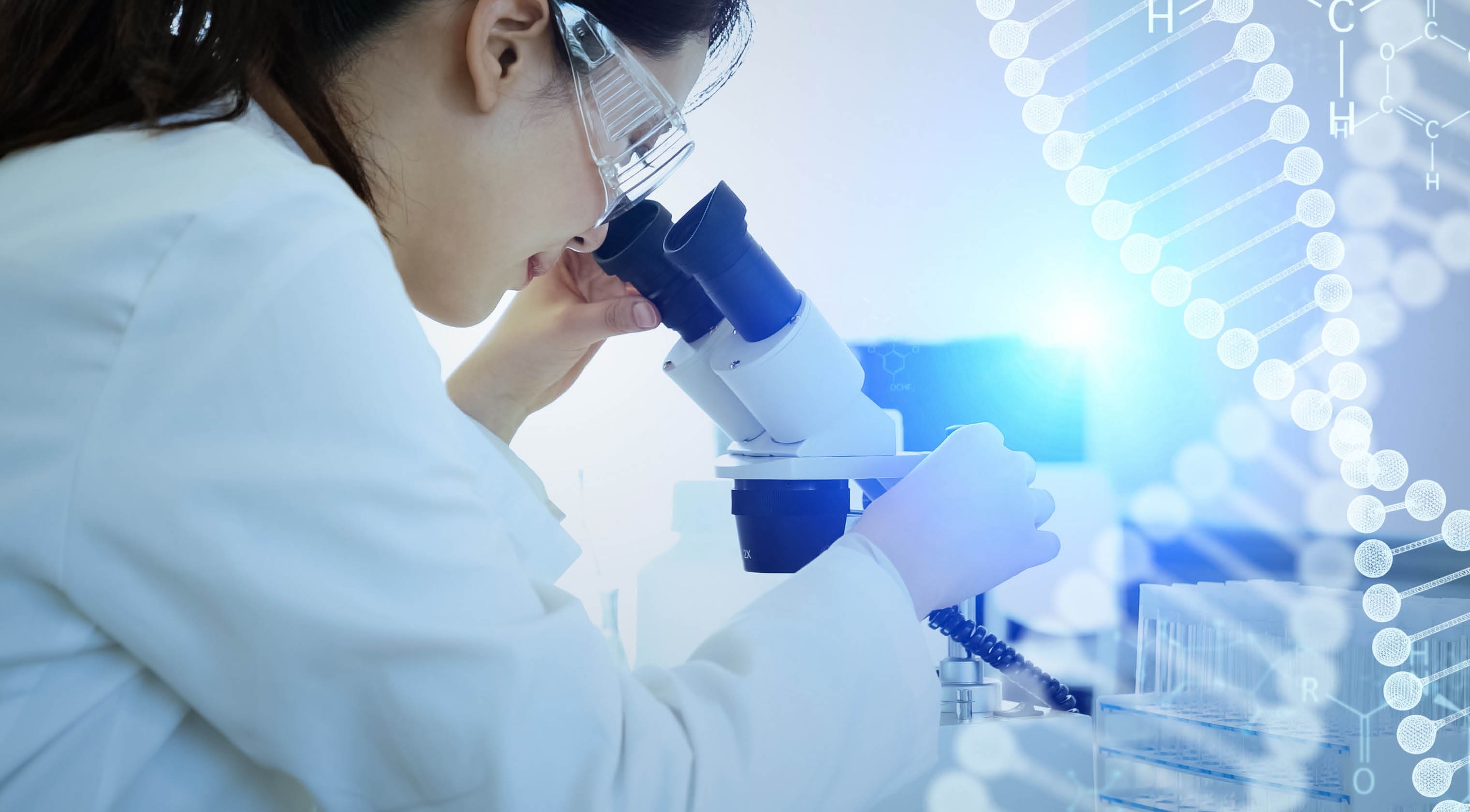 Female scientist looking into microscope